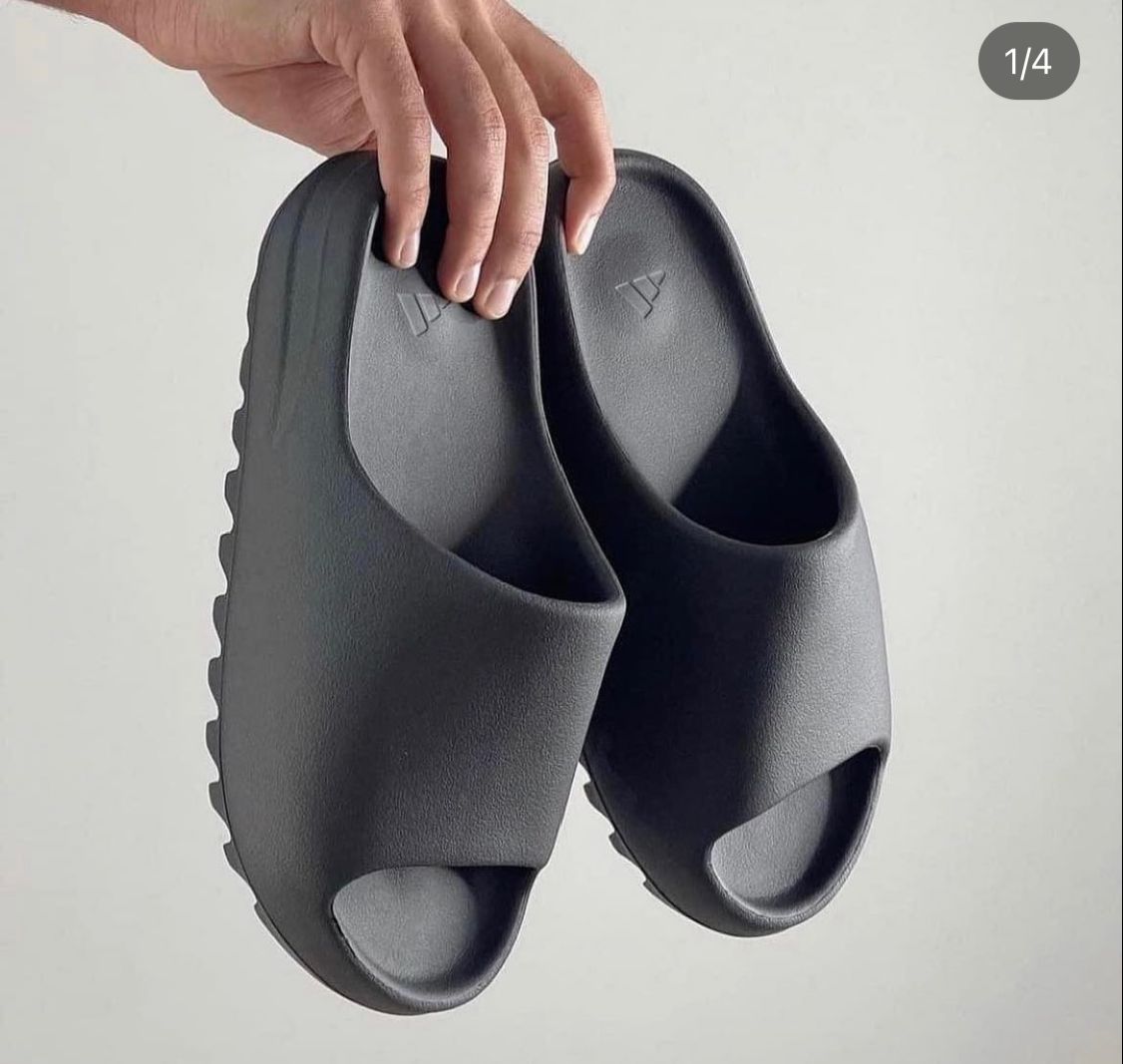 black yeezy slides on feet