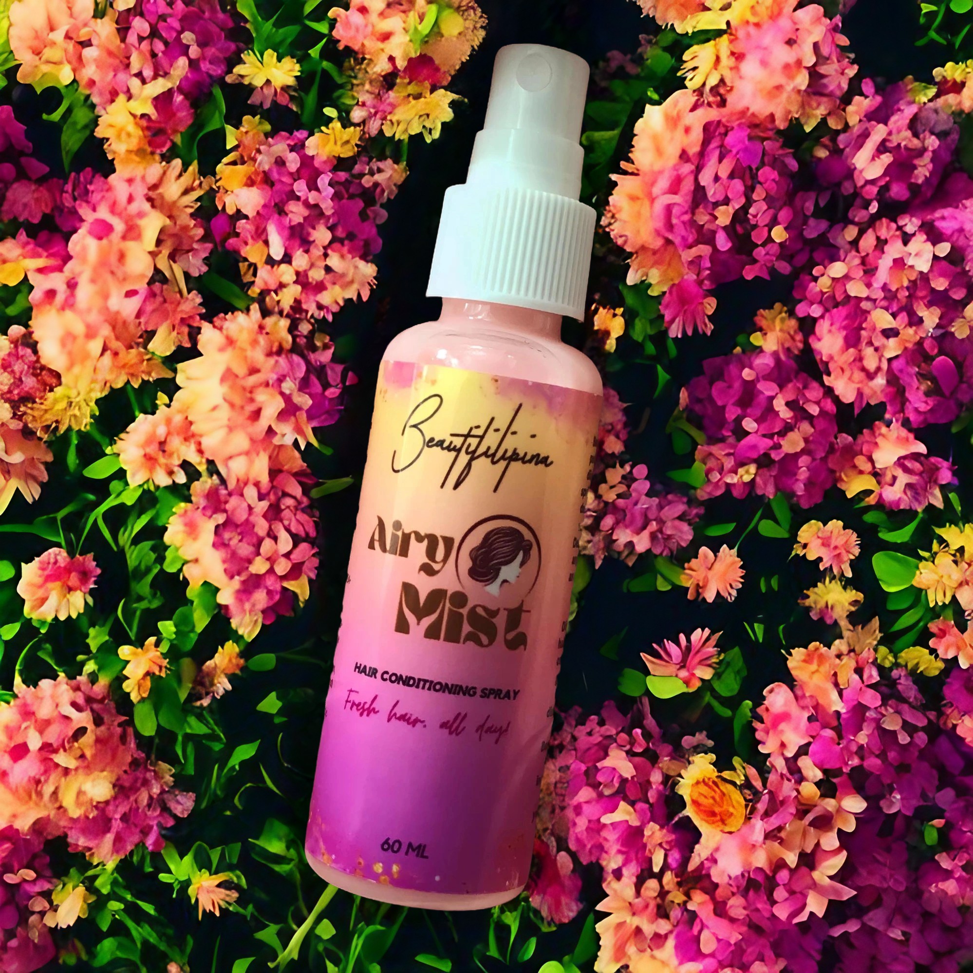 Beautifilipina Airy Mist Hair Conditioning Spray lays in a bed of fresh flowers